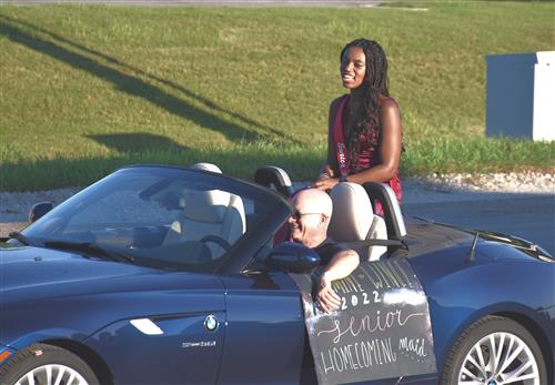 junior homecoming maid on back of convertible
